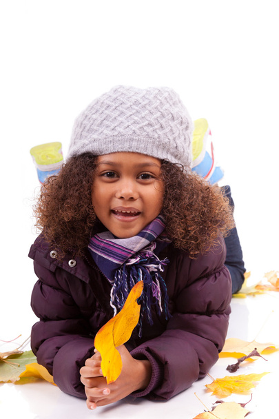 Little african asian girl wearing winter clothes playing with le - Foto, Bild