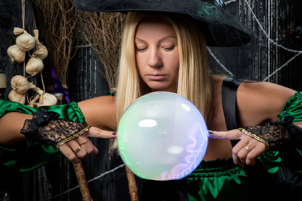 The witch looks into his magic ball and tries to see the future - Photo, Image