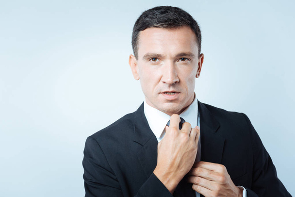 Nice handsome businessman fixing a tie - Photo, Image