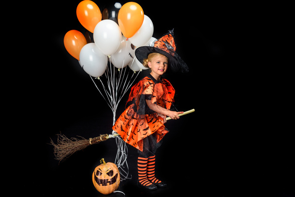 little witch with broom and balloons - Fotografie, Obrázek