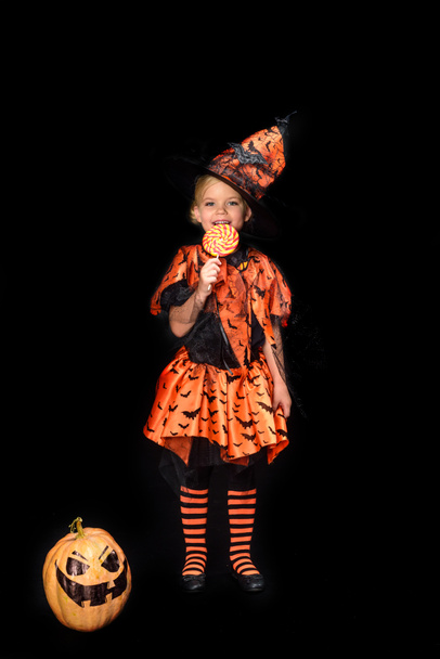little witch eating lollipop - Zdjęcie, obraz