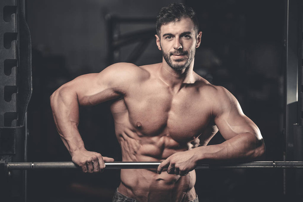 Caucasian sexy fitness male model execute exercise with barbell - Photo, image
