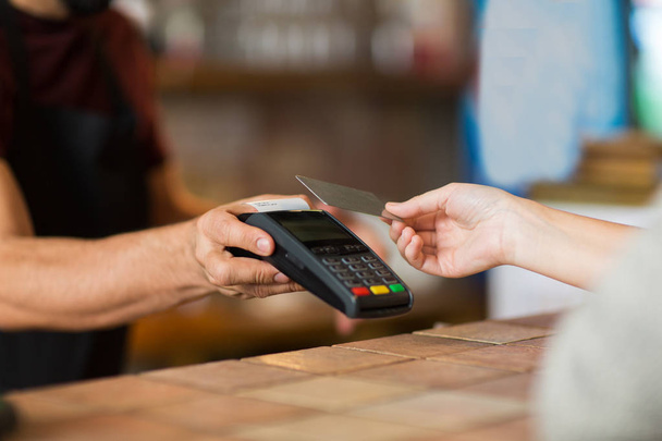 hands with payment terminal and credit card - Fotó, kép