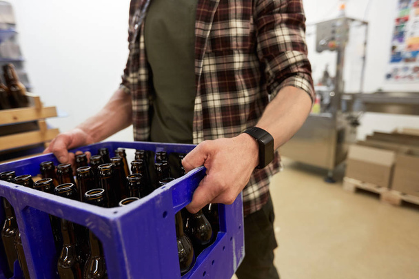 man with bottles in box at craft beer brewery - Foto, immagini