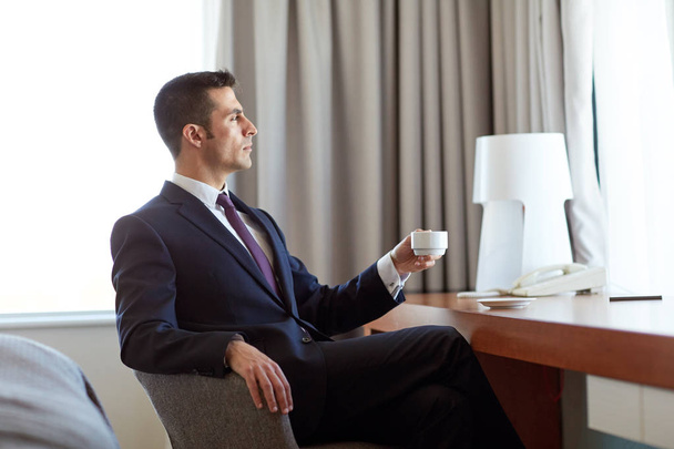 businessman drinking coffee at hotel room - Photo, image