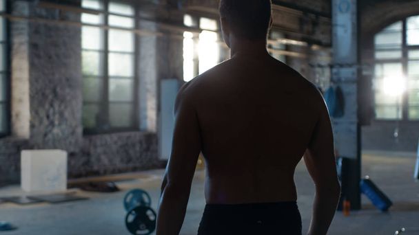 Shot from the back of Muscular Shirtless Man Entering Gym. He's  - Photo, Image