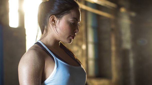Tired Beautiful Athletic Woman Looking Down after Intensive Cros - 写真・画像