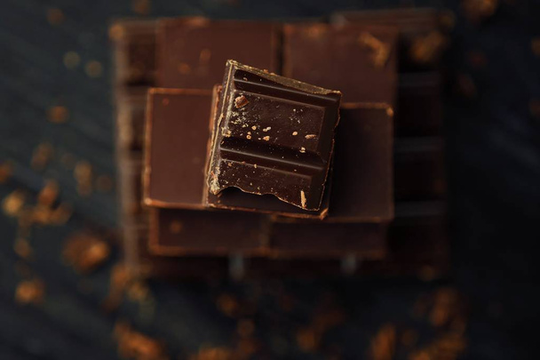 Delicious black and milk chocolate on a brown background  - Φωτογραφία, εικόνα