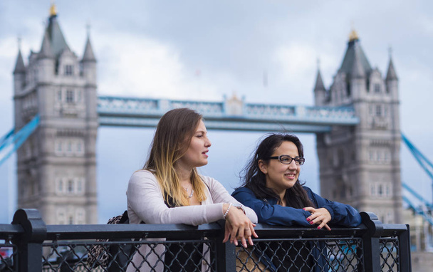 The Tower Bridge London with two girls on a sightseeing tour - Fotó, kép