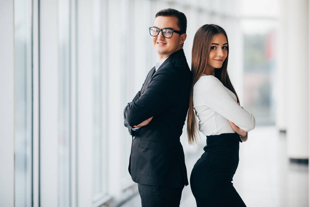 Business man and woman are standing with back to back - Photo, image