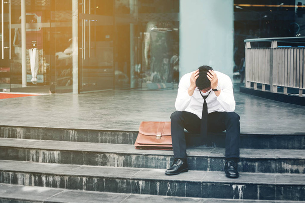 Unemployed Tired or stressed businessman sitting on the walkway  - Zdjęcie, obraz
