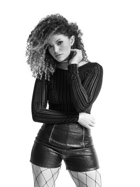 Beautiful woman portrait wearing black sweater and leather shorts, monochrome - Fotó, kép