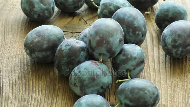 Delicious plums on the old wooden background - Footage, Video