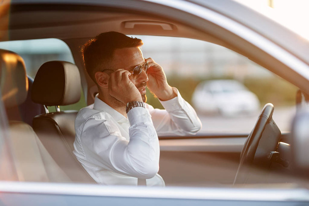 businessman wearing sunglasses while driving car - Фото, изображение