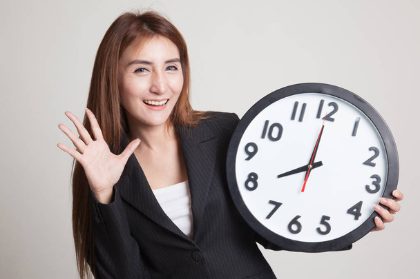 Happy Young Asian woman with a clock. - 写真・画像