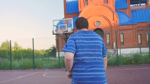 Młody facet grać Street Basketball - Materiał filmowy, wideo