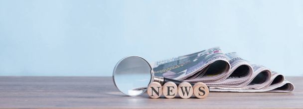 newspaper stack and magnifying glass background - Photo, Image