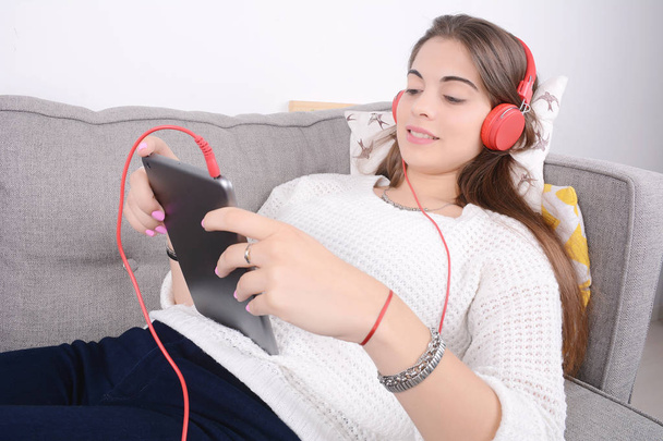 Woman listening music with tablet. - Valokuva, kuva
