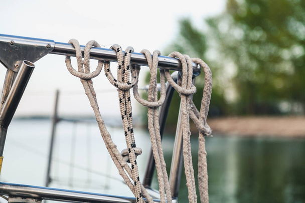 Several loops of rope on a steel handrail - Foto, afbeelding
