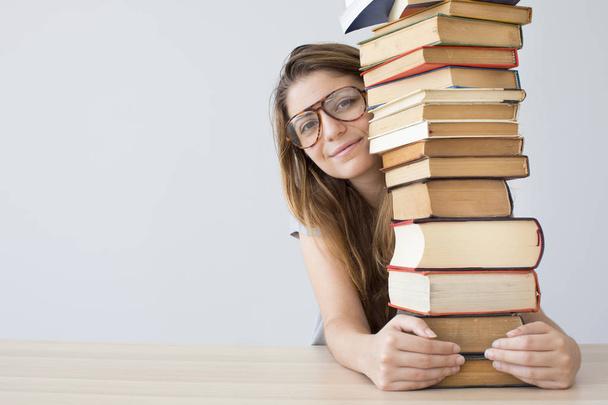Happy student with a pile of books - Foto, afbeelding