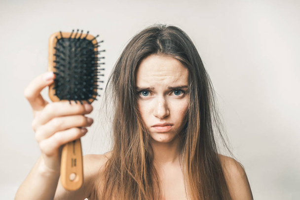 Problems with hair,lost hairs,woman with comb - Фото, изображение