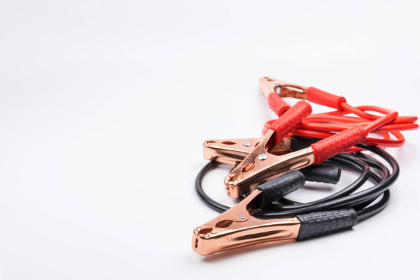 Two jumper cables for car battery isolated on white background. - Foto, Bild