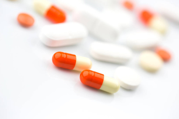 Pharmacy theme. Isolated Pills and Capsules on the White Surface. Closeup. - 写真・画像