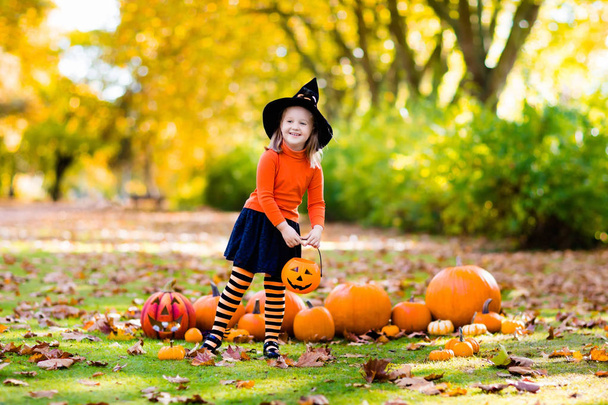 Little girl in witch costume on Halloween trick or treat - Fotó, kép