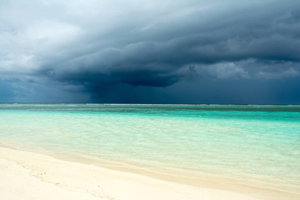 Bewolkt landschap van Indische oceaan zand strand voor de storm - Foto, afbeelding