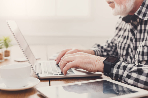 Senior man hands on laptop closeup - Photo, Image