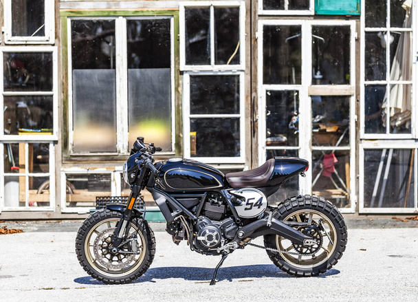 Custom made scrambler style cafe racer with standing in front of - Photo, Image