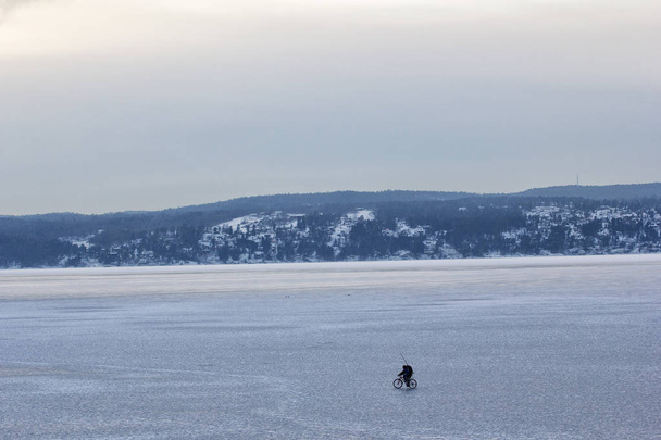 Man cycling on an iceberg on oslofjord norway - Photo, Image