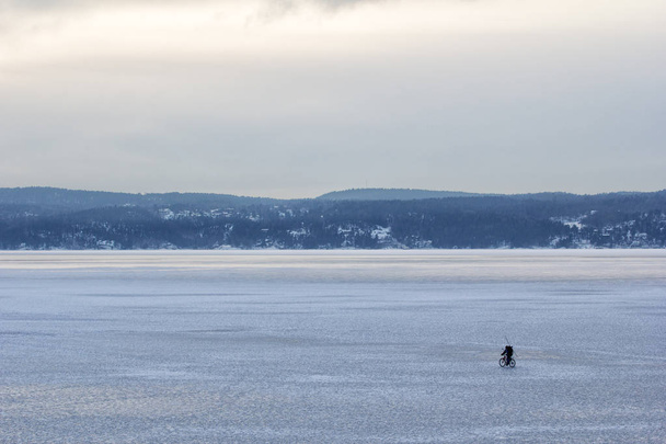Man cycling on an iceberg on oslofjord norway - Photo, Image