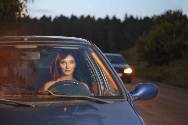 Girl driving the car in the evening - Zdjęcie, obraz