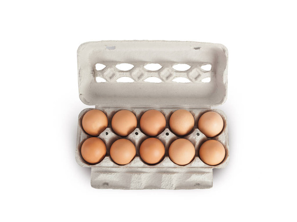 Eggs in cardboard rack on white background - Foto, Imagen