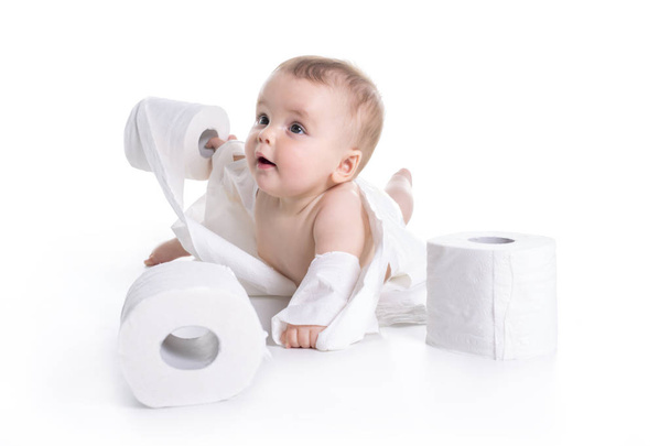 Toddler ripping up toilet paper in bathroom studio - Foto, imagen