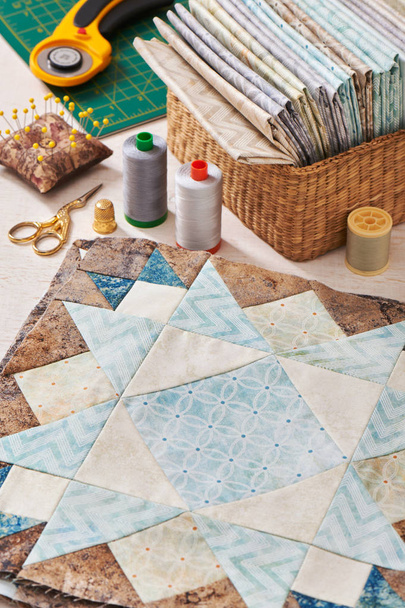 Prepared blocks for sewing quilt, stack of fabrics, sew accessories - Φωτογραφία, εικόνα