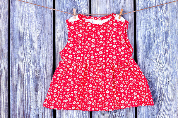 Baby red dress hanging on clothesline. - Photo, Image