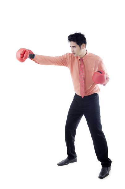 Young businessman punching something on studio - Photo, Image