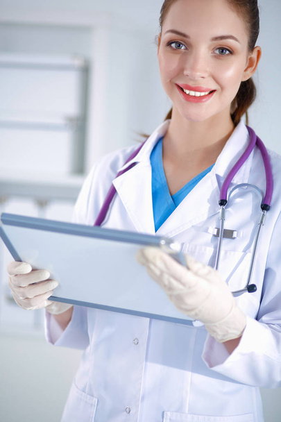 Woman doctor standing with folder at hospital - Foto, Bild