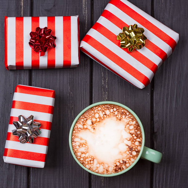 cup of hot cocoa or chocolate with marshmallow and gift boxes - Photo, Image