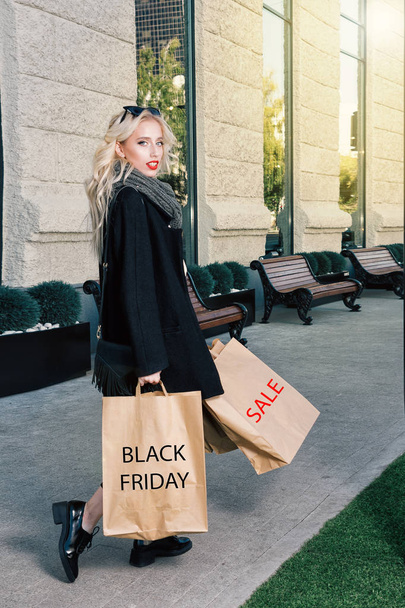 Young blonde woman with shopping bags.  - Photo, Image