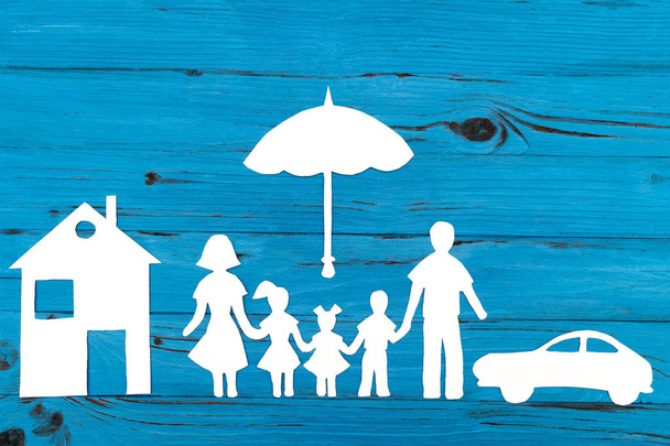 Closeup of happy paper family on blue background - Photo, Image