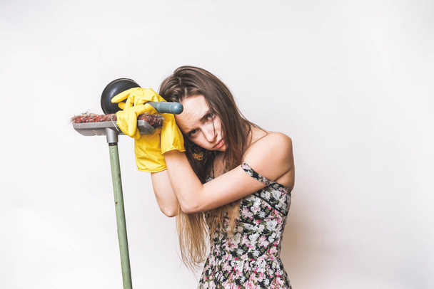 Frustrated young woman cleaning with mop and plunger - Fotoğraf, Görsel