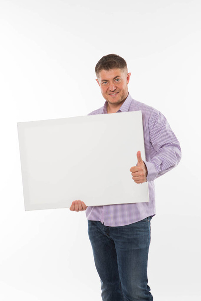 Young confident man showing presentation, pointing on placard. - Fotoğraf, Görsel