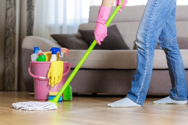woman in protective gloves using a wet-mop while cleaning floor - 写真・画像
