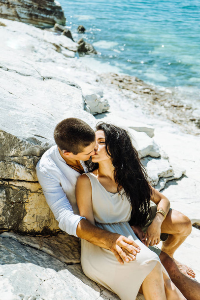 A pair of lovers kissing stones near the water - Φωτογραφία, εικόνα