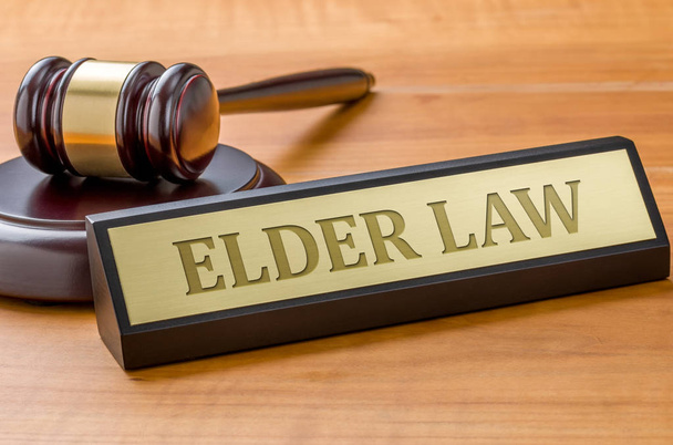 A gavel and a name plate with the engraving Elder law - Photo, Image