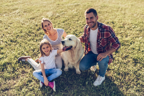 Happy family with dog - Foto, afbeelding