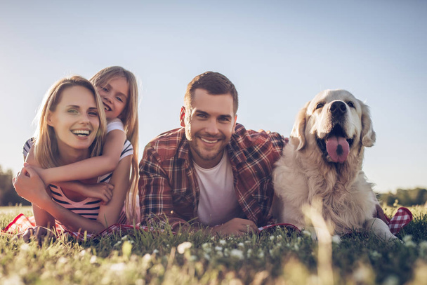 Happy family with dog - Фото, зображення